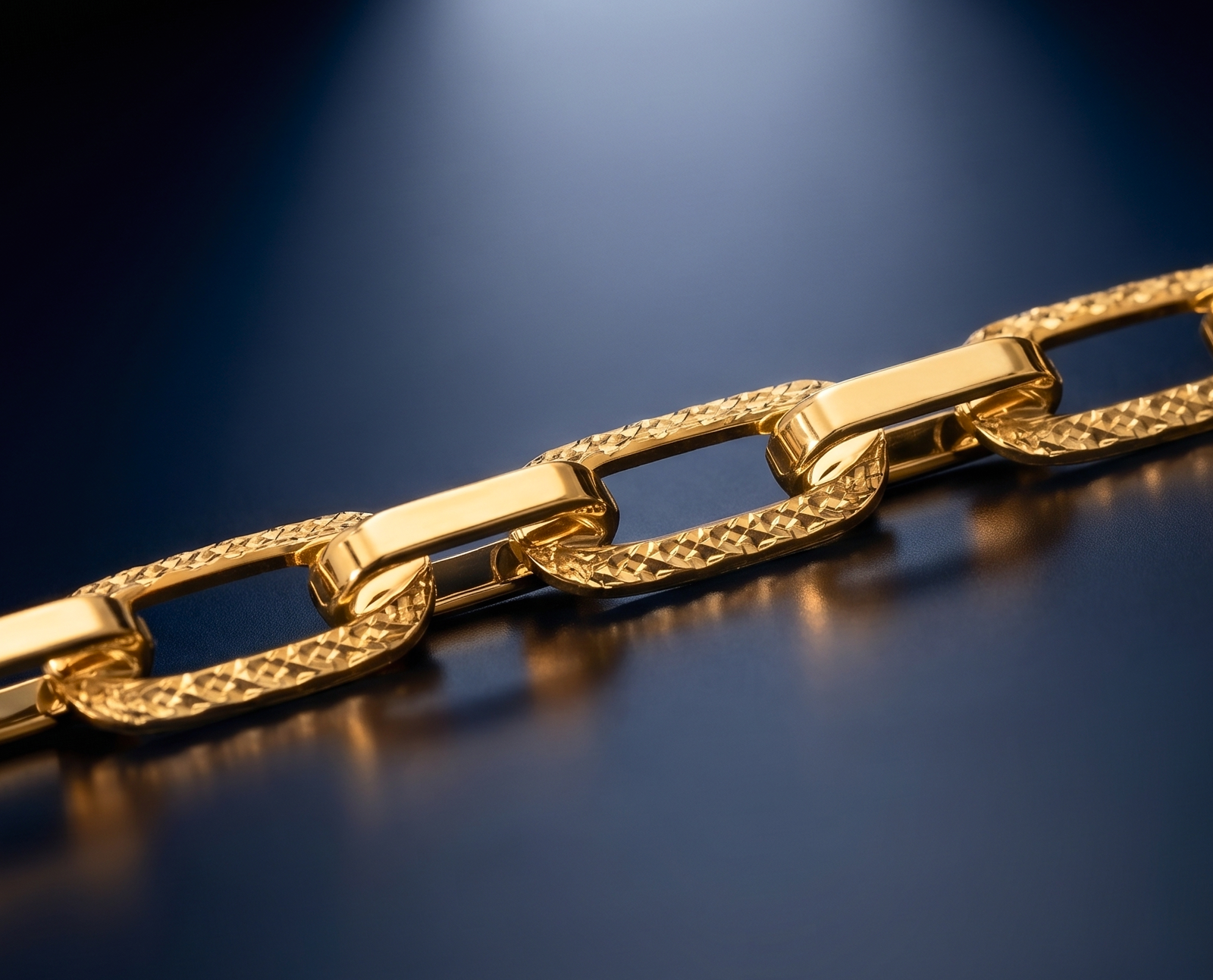 Close-up of solid 10K yellow gold links catching the light on a dark surface