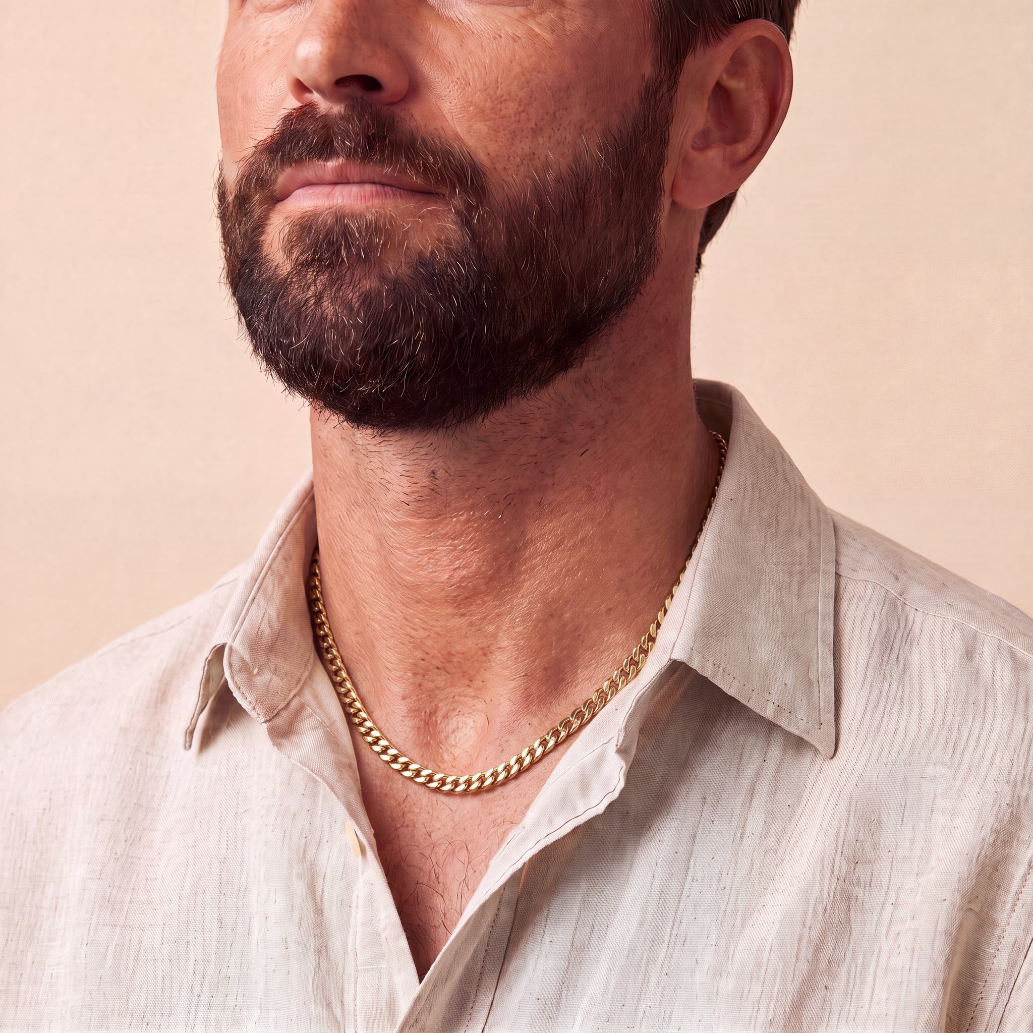 Man wearing a 10K yellow gold Horizon Commanding curb chain necklace, 7.3mm