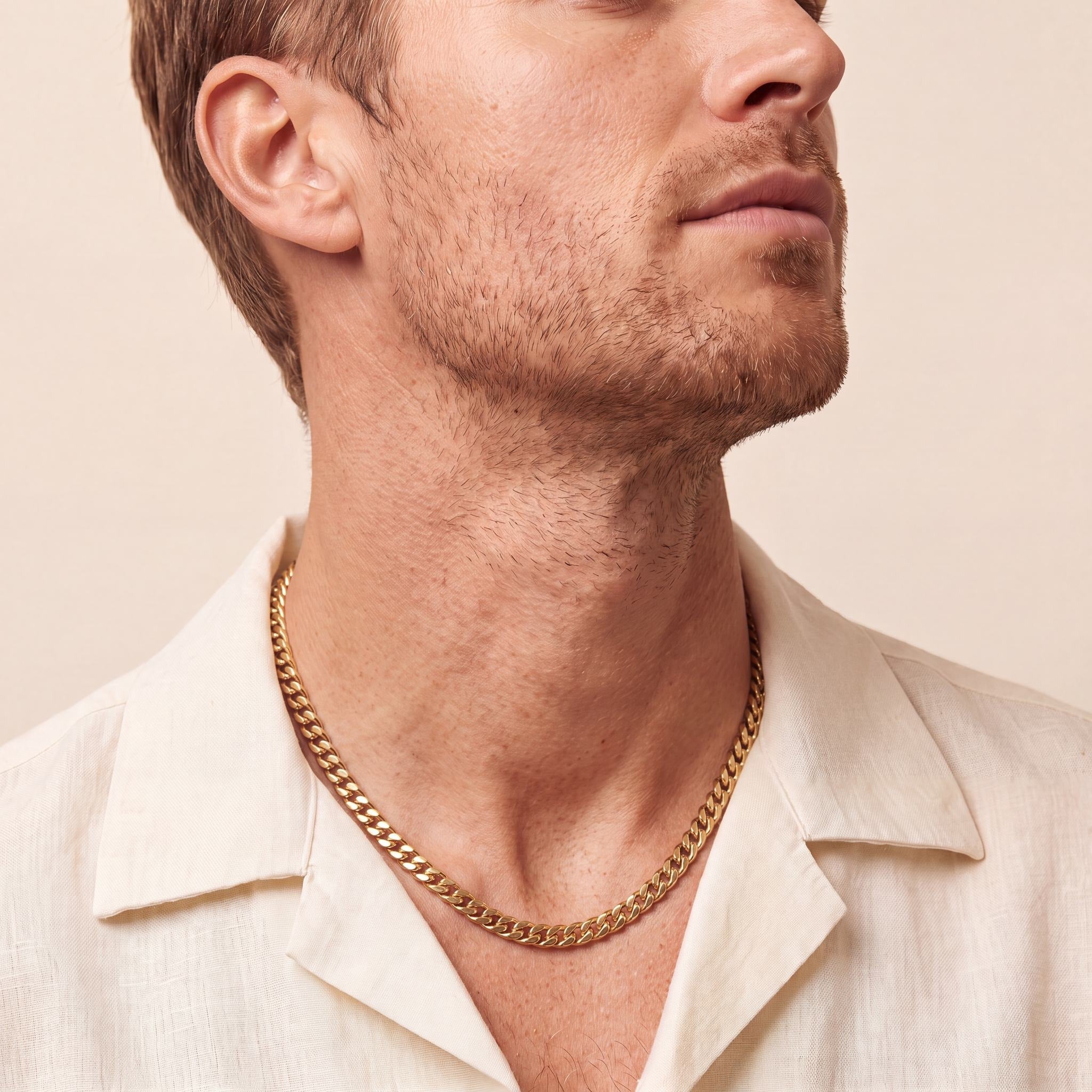 Man wearing a 10K yellow gold Horizon Striking curb chain necklace, 5.6mm