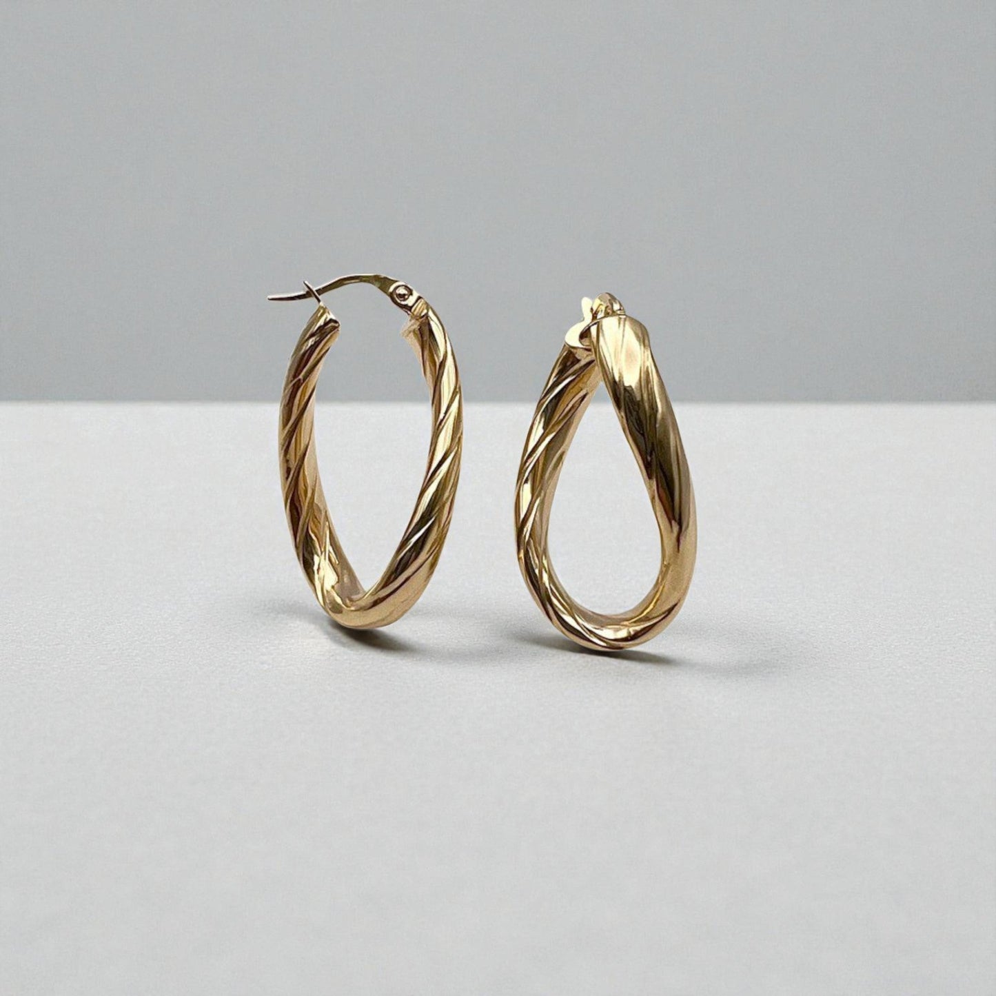 10K Yellow Gold Aqueous Twist Hoop Earrings - wavy ribbed oval design