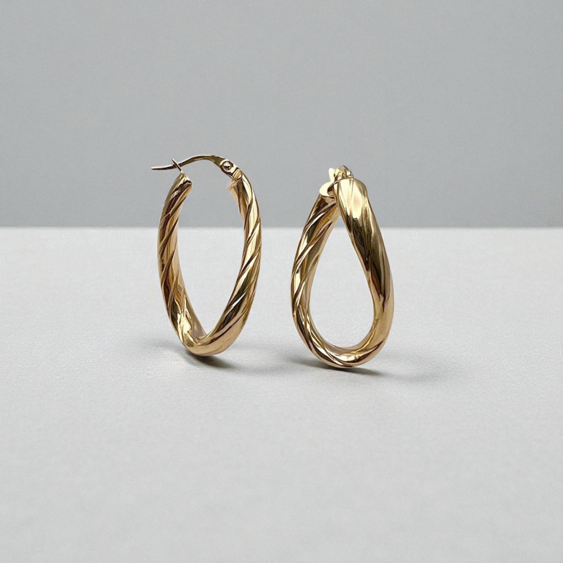 10K Yellow Gold Aqueous Twist Hoop Earrings - wavy ribbed oval design